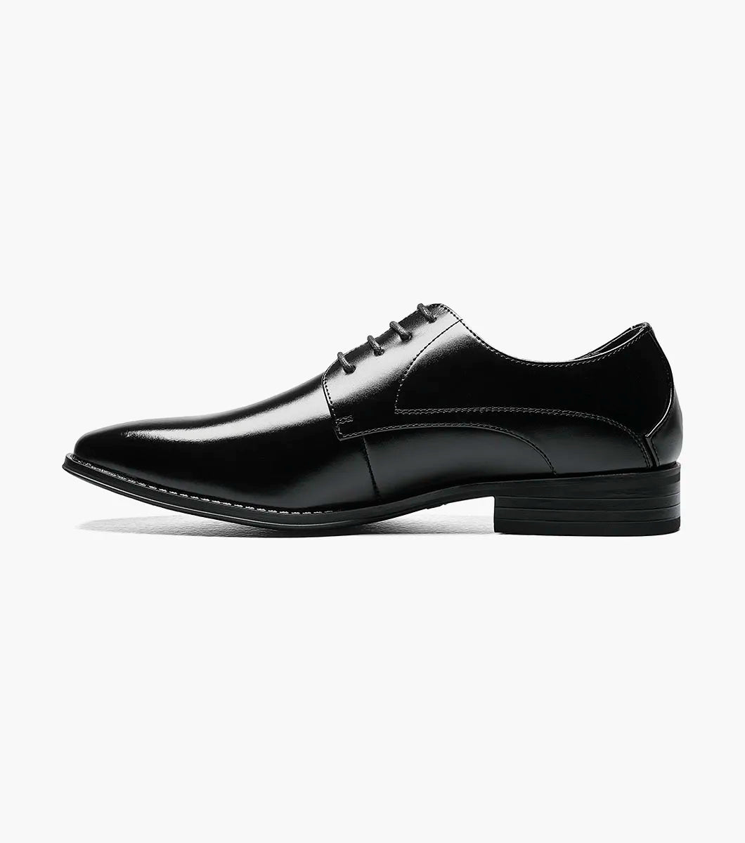 The STACY ADAMS Wayde Plain Toe Oxford (Black, 20144-001) is a leather lace-up dress shoe with a low heel, cushioned footbed, and polished finish, shown here on a plain white background.