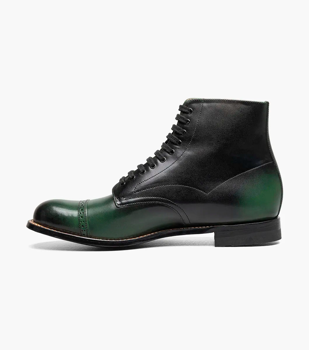 The Stacy Adams Madison Cap Toe Lace Up Boot (00110-300) features a dark green leather upper, black sole, brown welt, and closed lacing—an elegant STACY ADAMS dress boot shown on a white background.