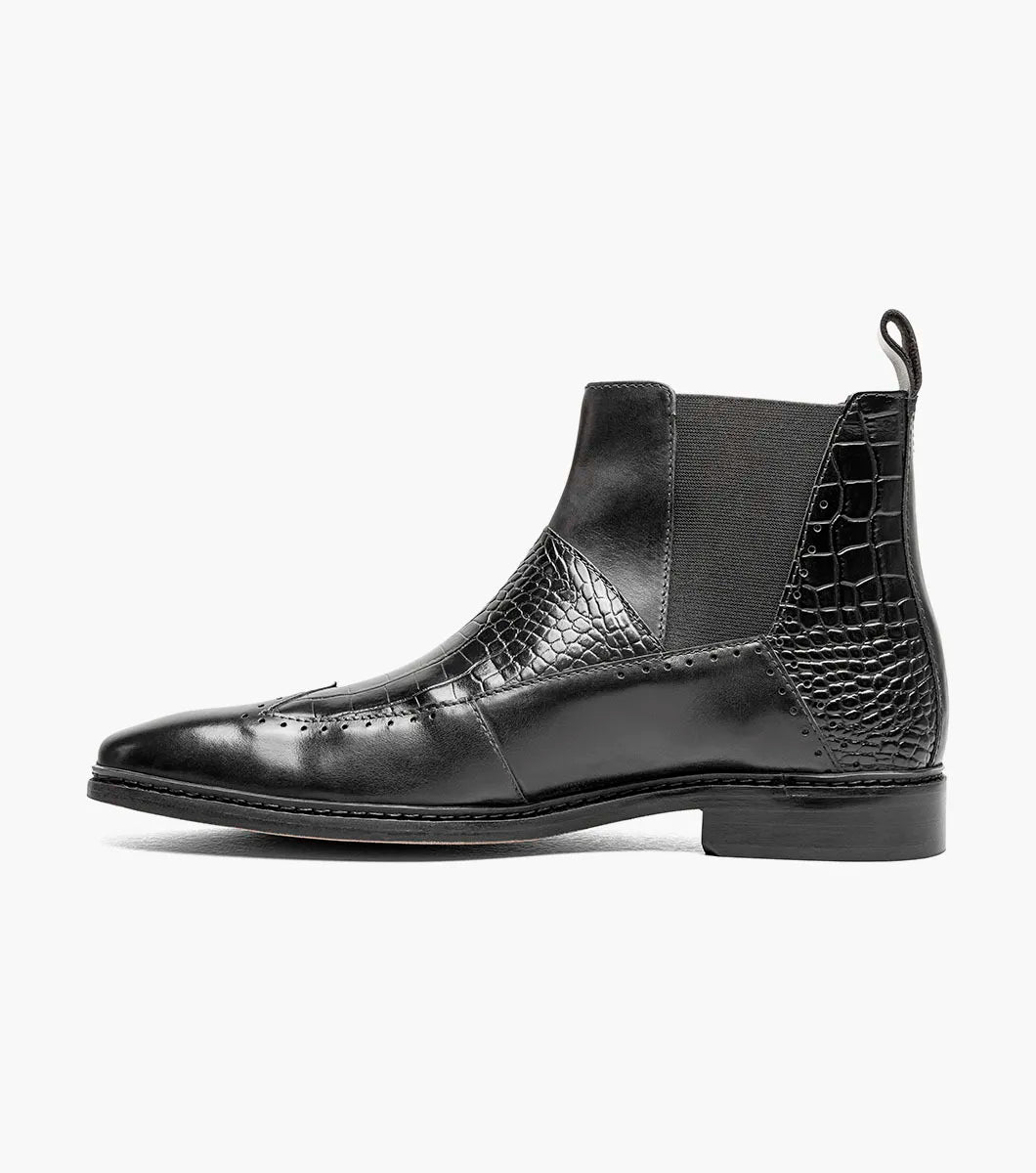 The Stacy Adams Garza Wingtip Chelsea Boot (Black, 25782-001) features crocodile texture accents, elastic side panels, a heel pull tab, and a low heel on a flat sole.