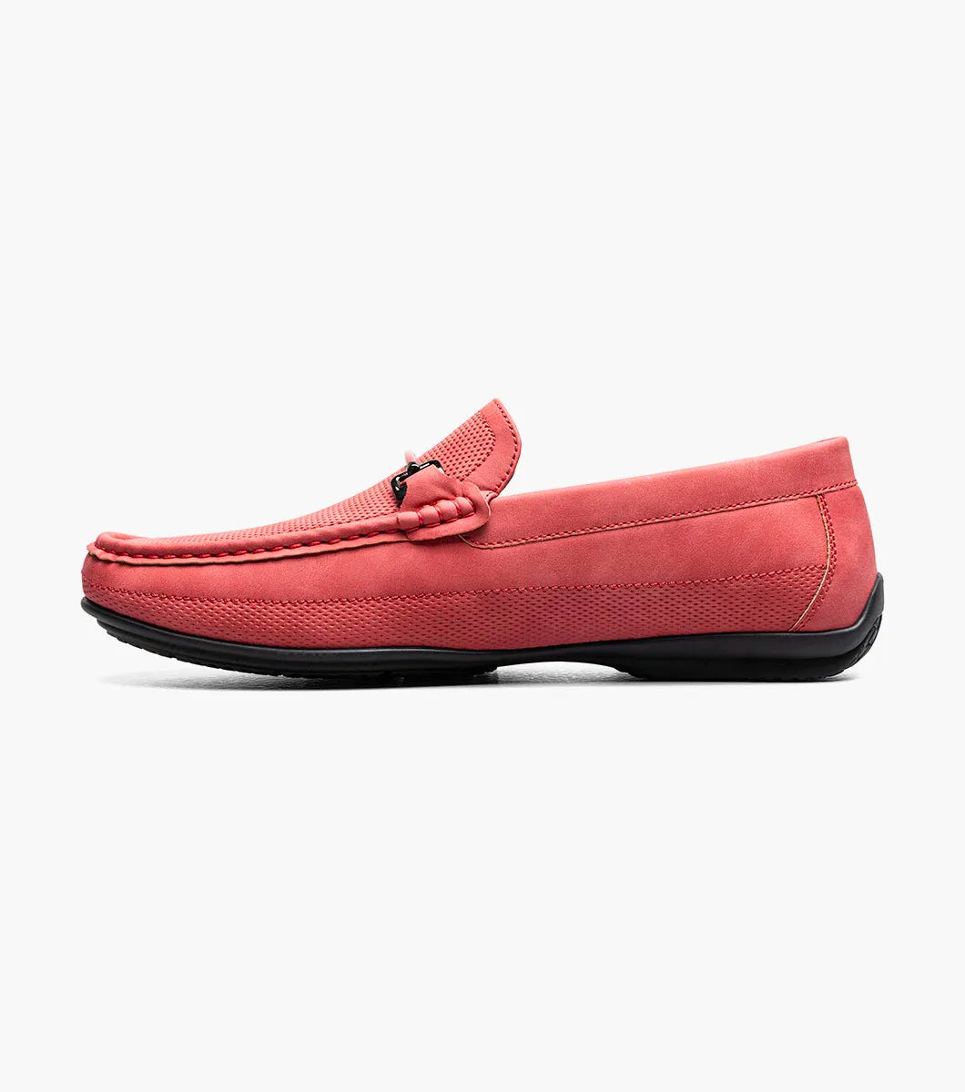 The Stacy Adams Colton Moc Toe Bit Slip On (25760-600) is a red suede loafer featuring a metal bit detail, visible stitching, black sole, striped inner lining, and cushioned footbed for comfort.