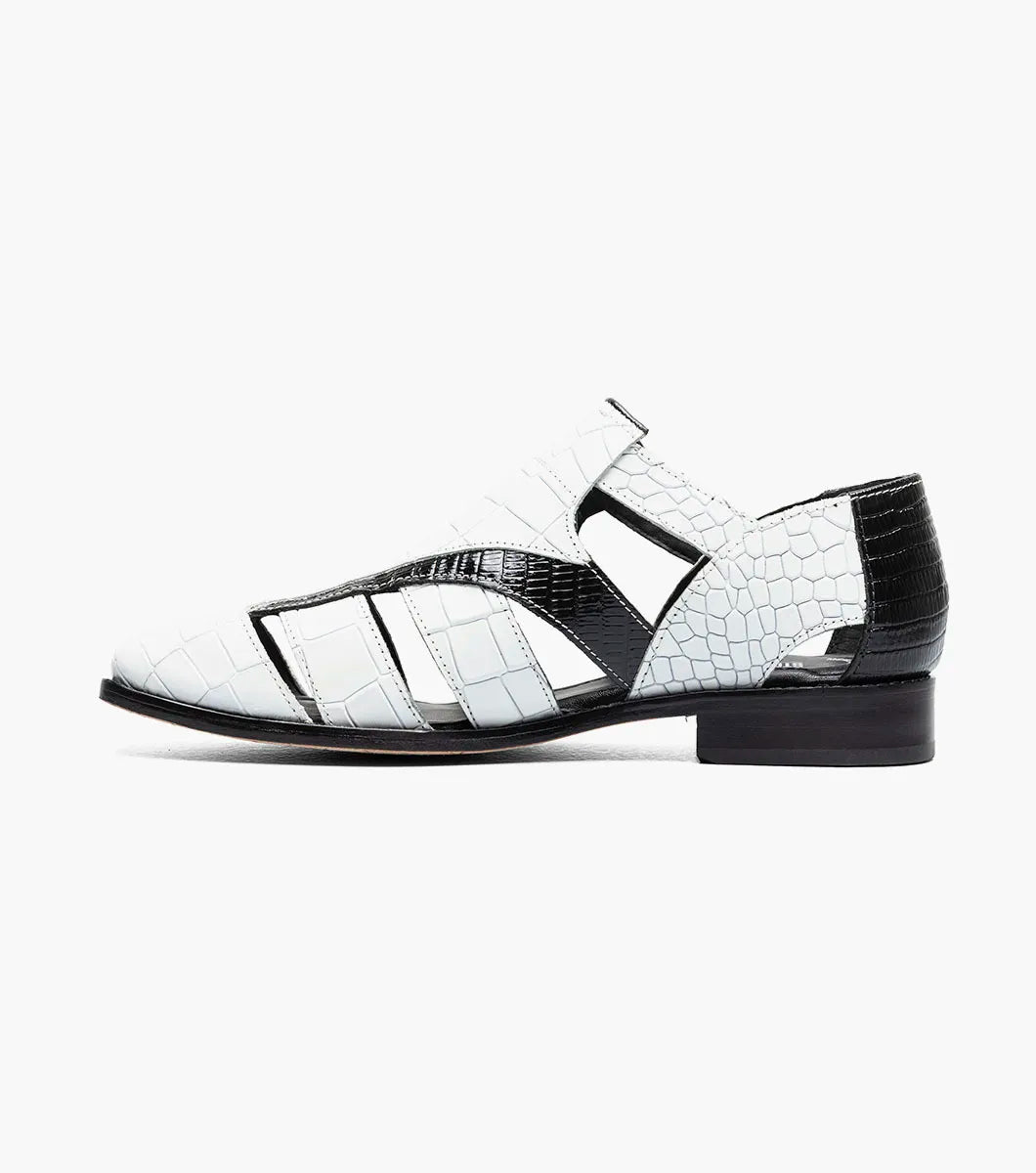 The Stacy Adams Calandro City Sandal (25695-111) features a black and white closed-toe design with cut-out sections, buckle strap, low heel, textured crocodile print leather, and a genuine leather sole.