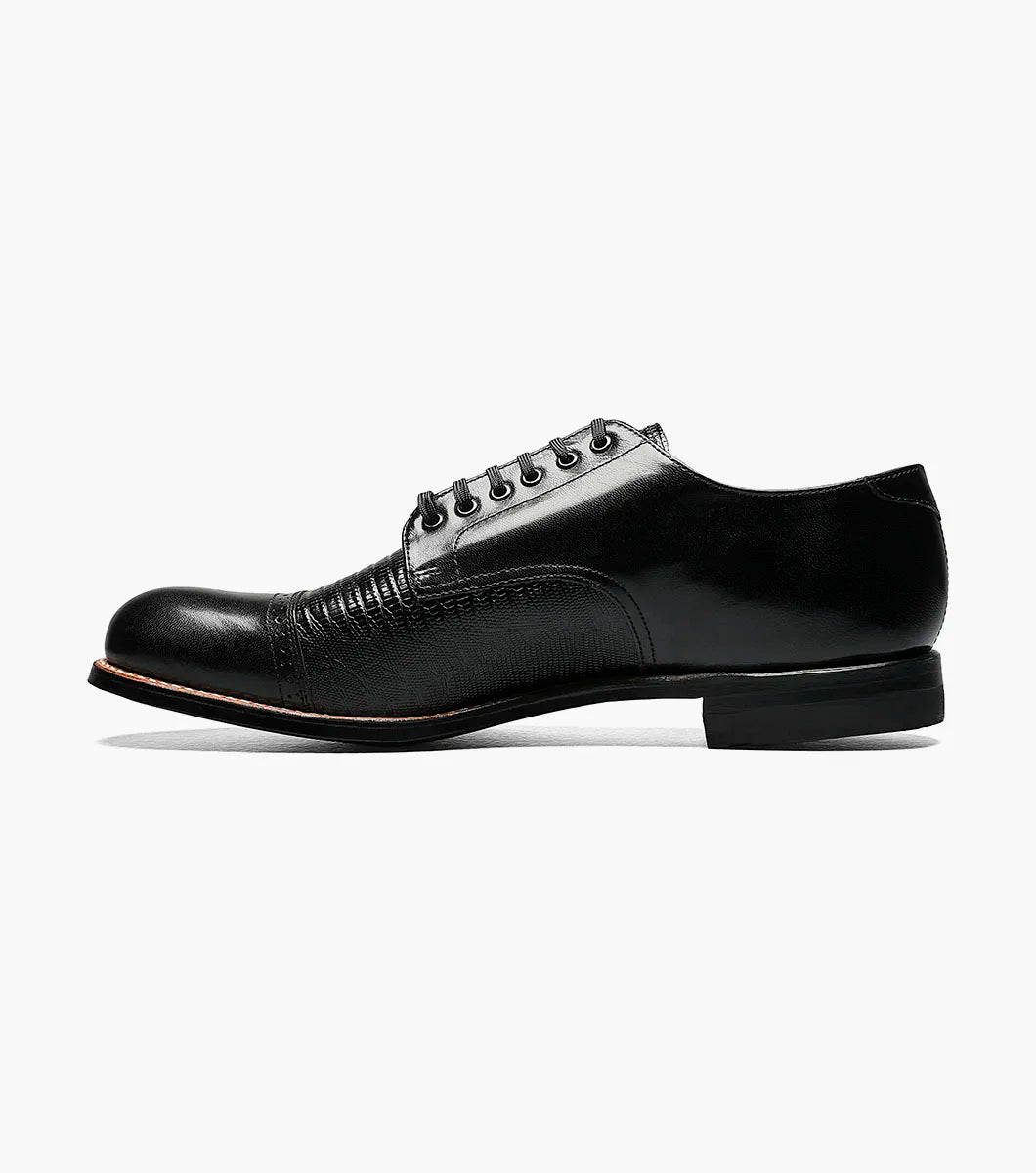 The Stacy Adams Madison Lizard Cap Toe Oxford (00049-01) is a black kidskin leather dress shoe for men, featuring a lizard print cap toe and five eyelets, shown against a white background. Brand: STACY ADAMS.