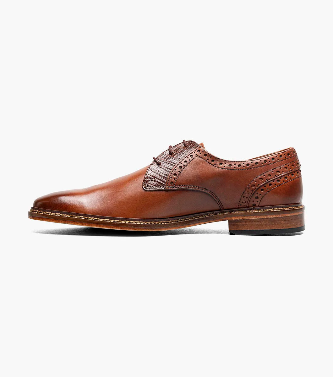 The Stacy Adams Giorgetti Plain Toe Oxford in Cognac features lizard print leather, brogue details, textured accents, a cushioned footbed, low heel, and lace-up closure.