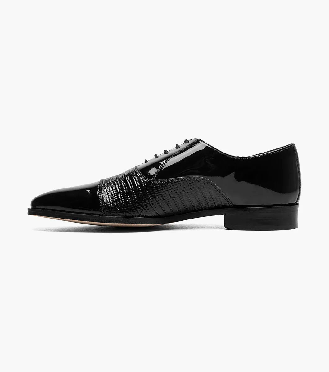 The Stacy Adams Razzeto Cap Toe Oxford in black features a patent leather lizard print, textured midsection, lace-up closure, and RedZone footbed for comfort, shown against a white background.