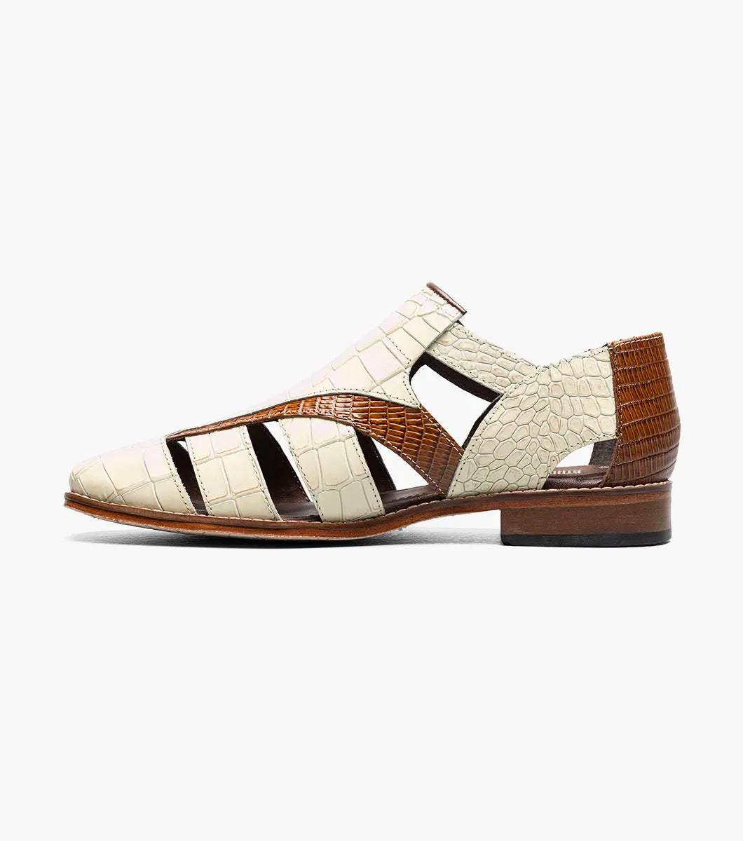 The Stacy Adams Calandro City Sandal in Ivory Multi (25695-114) features crocodile print leather, cream and brown color, closed toe, side buckle, cut-out details, cushioned footbed, and low heel.