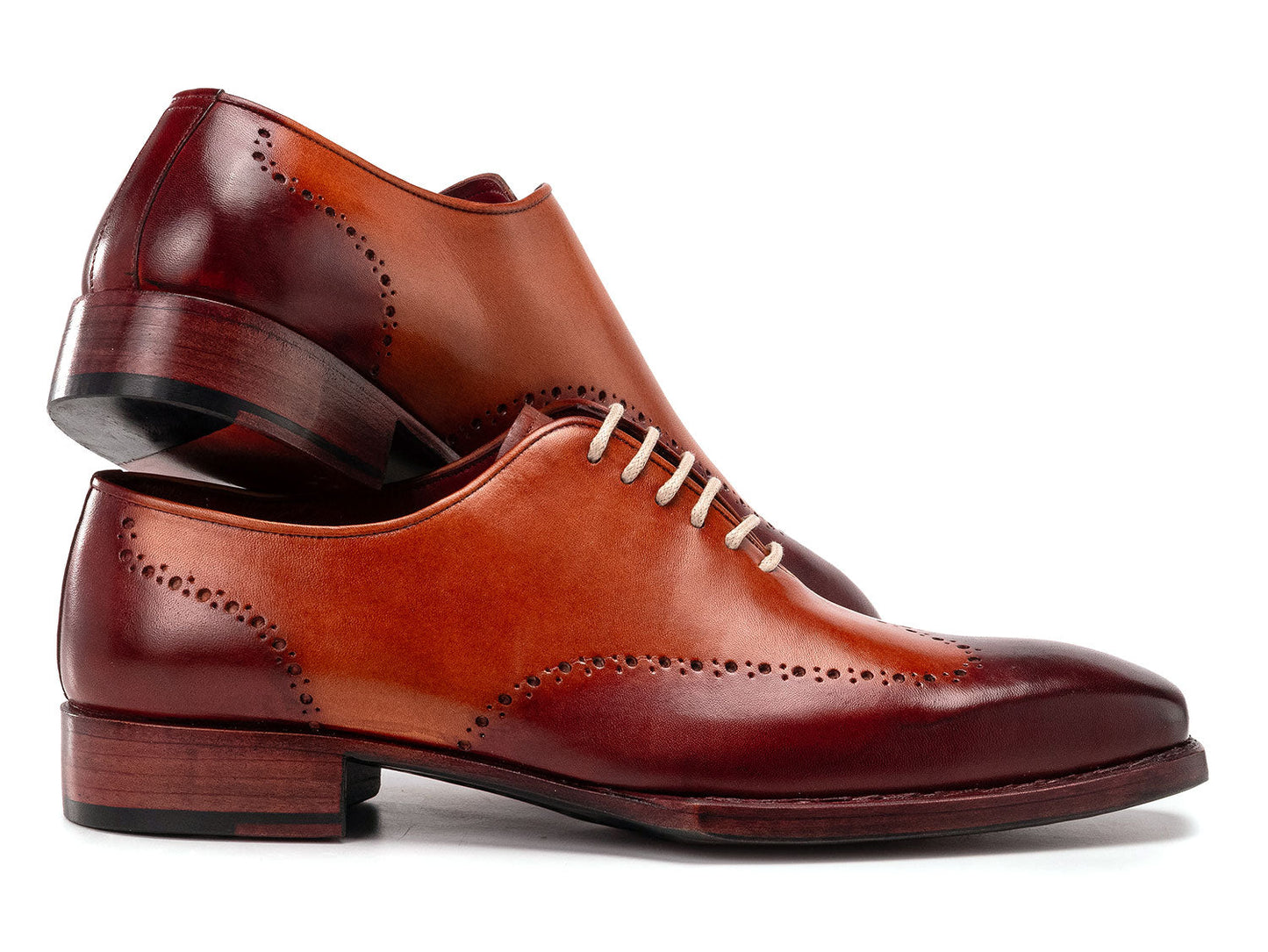 The Paul Parkman Goodyear Welted Wingtip Oxfords Bordeaux & Camel - 081-RDT feature two-tone brown and burgundy hues with brogue detailing, shown on a white background.