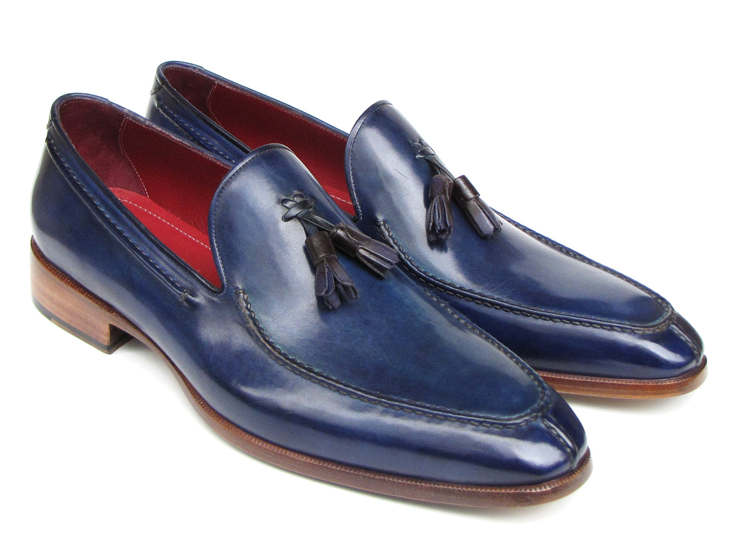 The Paul Parkman Tassel Loafer Blue Hand Painted Leather - 083-BLU is a men's slip-on shoe with blue hand-painted leather, brown soles, and a striking red inner lining, shown on a white background.