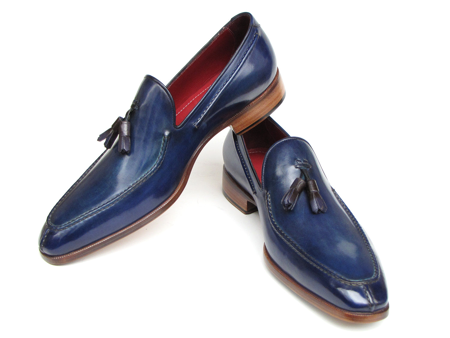 The Paul Parkman Tassel Loafer Blue Hand Painted Leather - 083-BLU is a men's slip-on shoe with blue hand-painted leather, brown soles, and a striking red inner lining, shown on a white background.