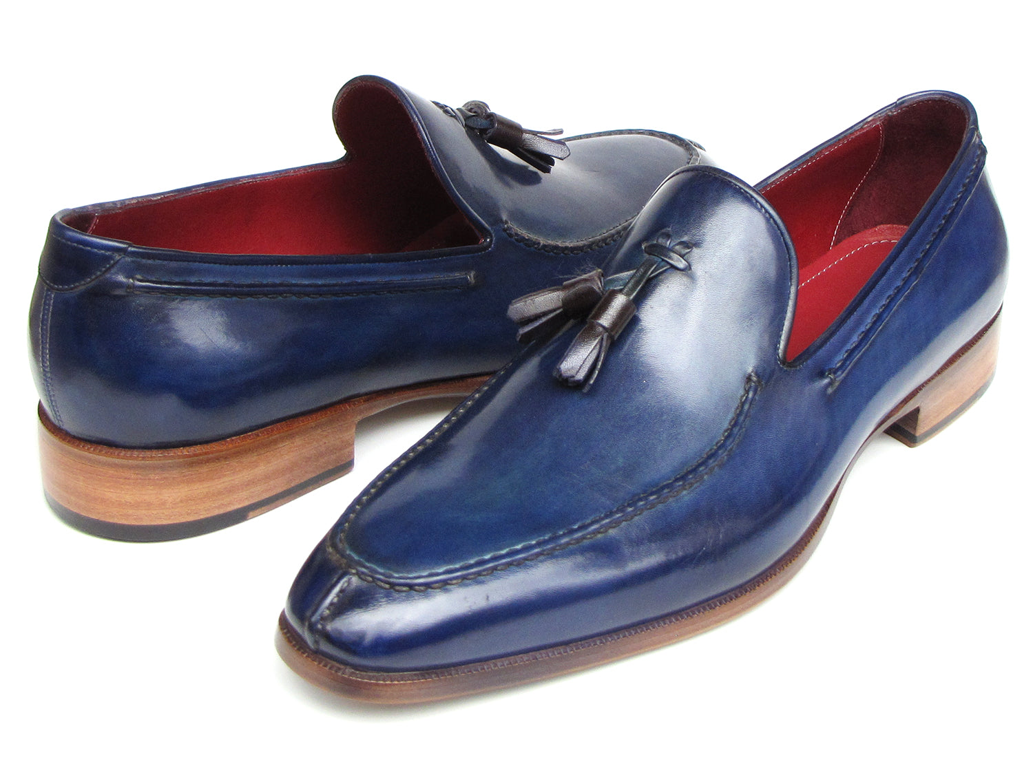The Paul Parkman Tassel Loafer Blue Hand Painted Leather - 083-BLU is a men's slip-on shoe with blue hand-painted leather, brown soles, and a striking red inner lining, shown on a white background.