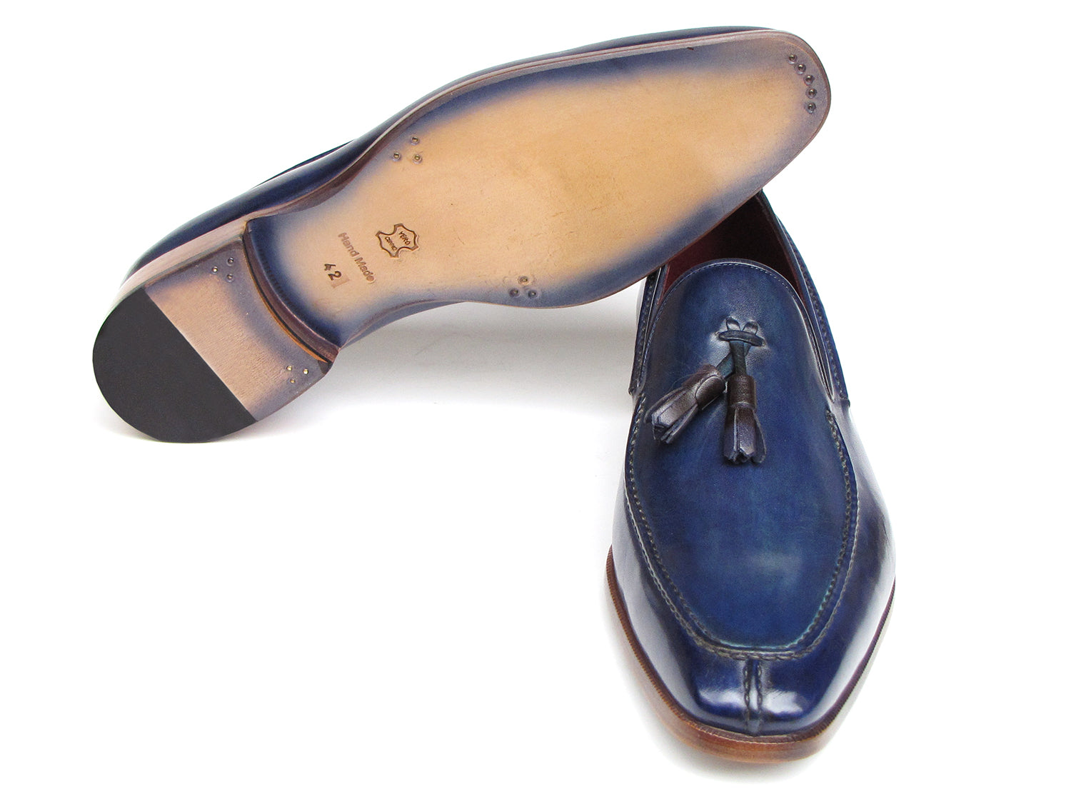 The Paul Parkman Tassel Loafer Blue Hand Painted Leather - 083-BLU is a men's slip-on shoe with blue hand-painted leather, brown soles, and a striking red inner lining, shown on a white background.