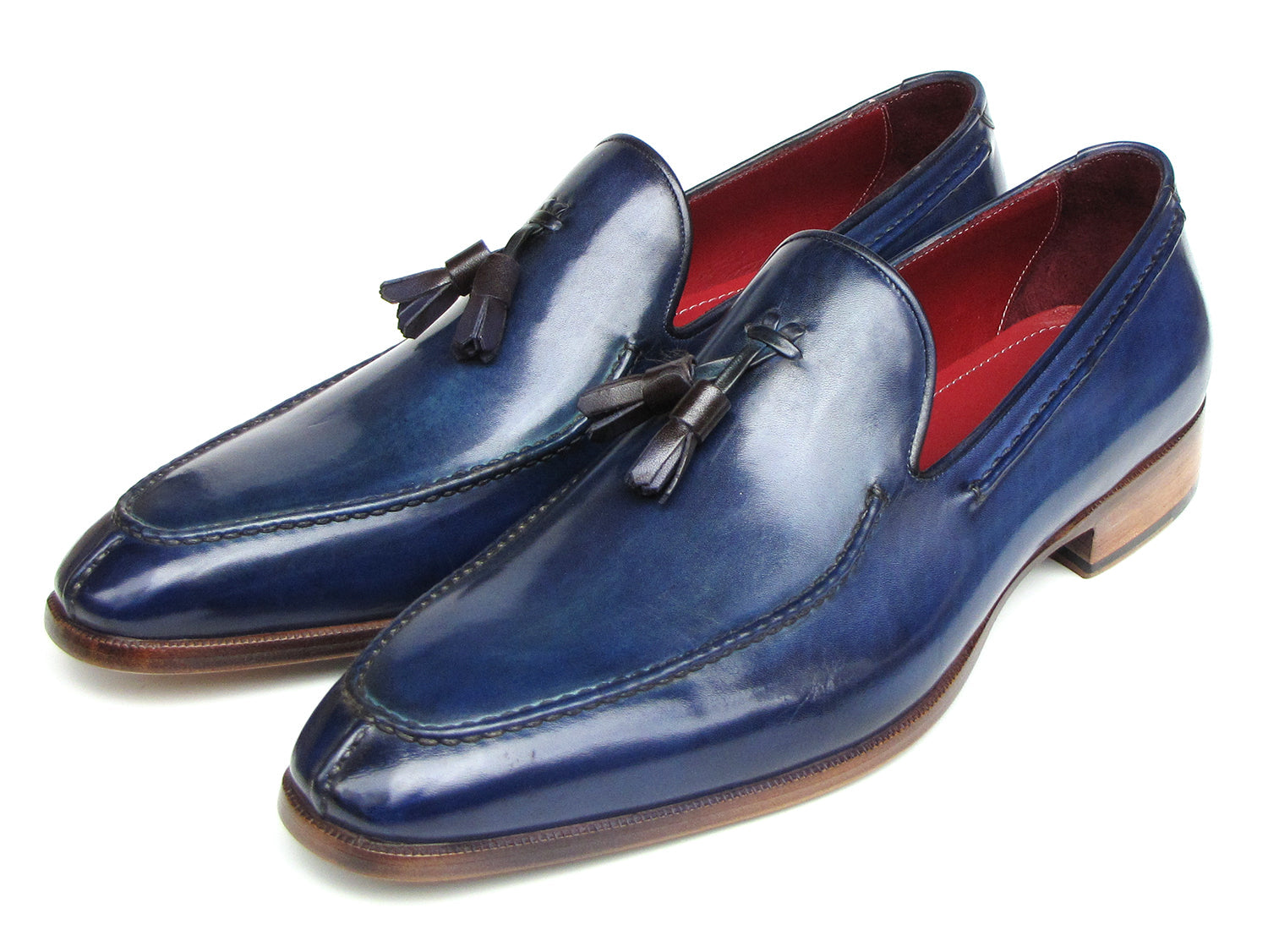 The Paul Parkman Tassel Loafer Blue Hand Painted Leather - 083-BLU is a men's slip-on shoe with blue hand-painted leather, brown soles, and a striking red inner lining, shown on a white background.