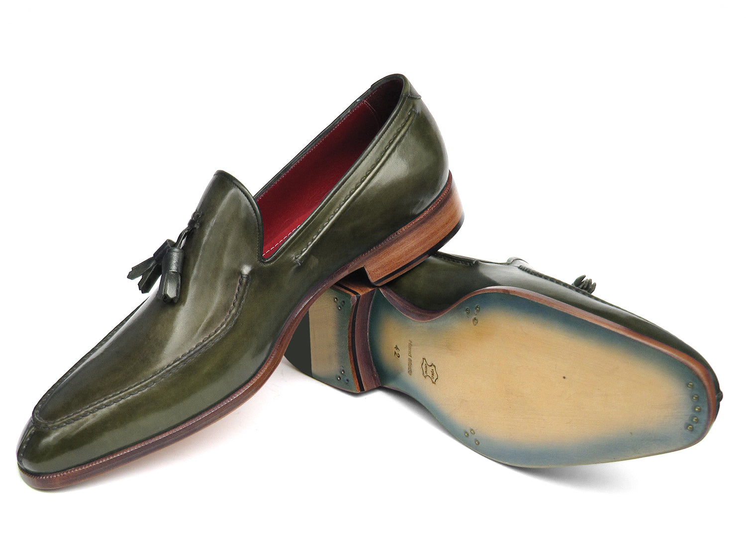The Paul Parkman Tassel Loafer Green Hand Painted Leather - 083-GREEN features a pair of green hand-painted leather loafers with tassels and brown wooden soles; one shoe is upright, the other displays its sole.