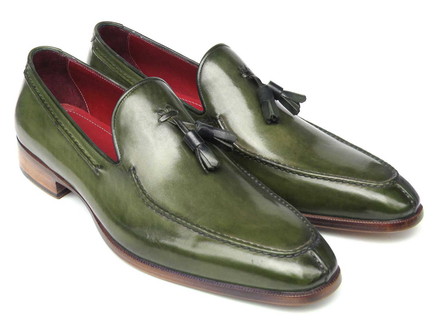 The Paul Parkman Tassel Loafer Green Hand Painted Leather - 083-GREEN features a pair of green hand-painted leather loafers with tassels and brown wooden soles; one shoe is upright, the other displays its sole.