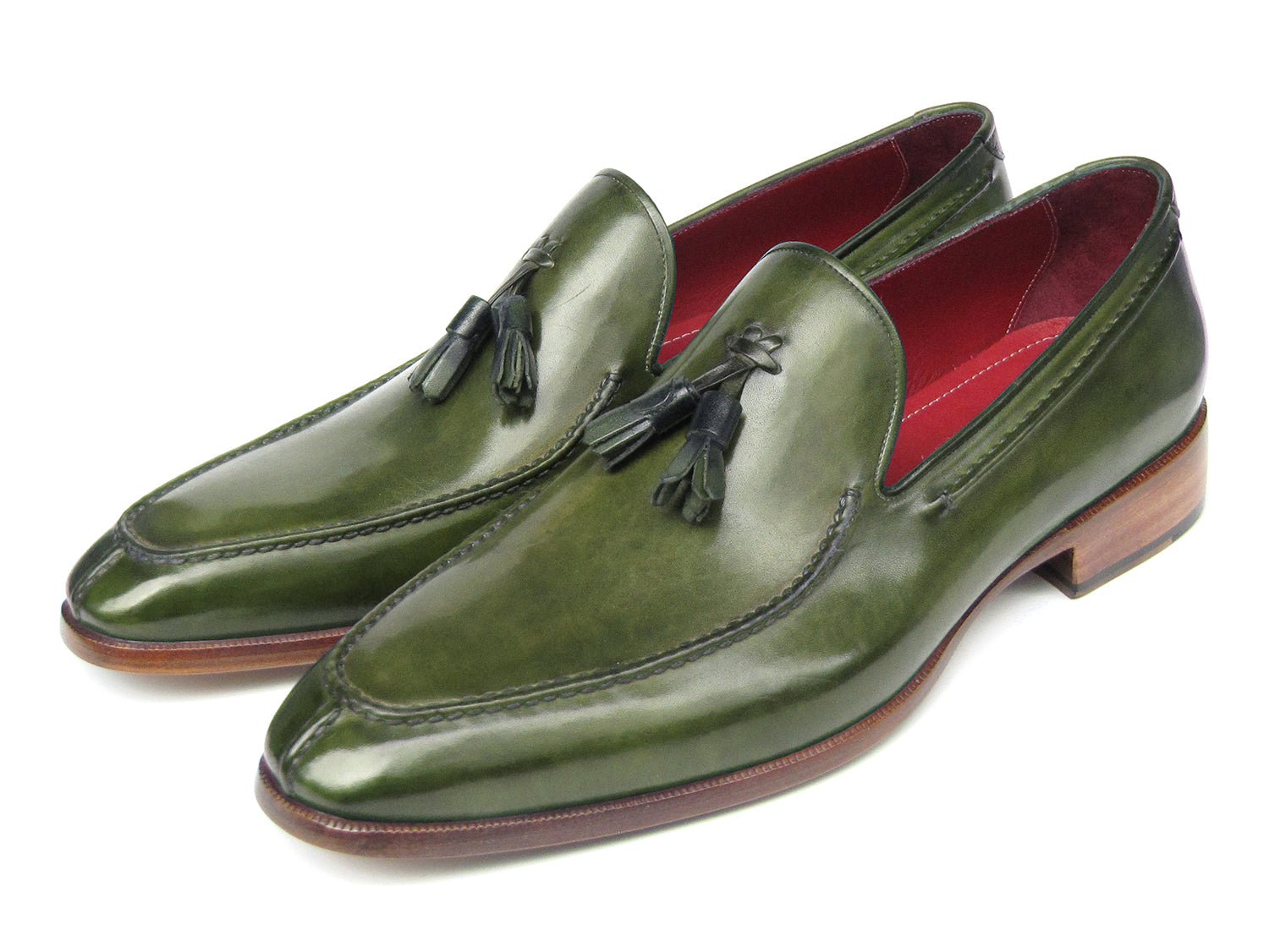 The Paul Parkman Tassel Loafer Green Hand Painted Leather - 083-GREEN features a pair of green hand-painted leather loafers with tassels and brown wooden soles; one shoe is upright, the other displays its sole.