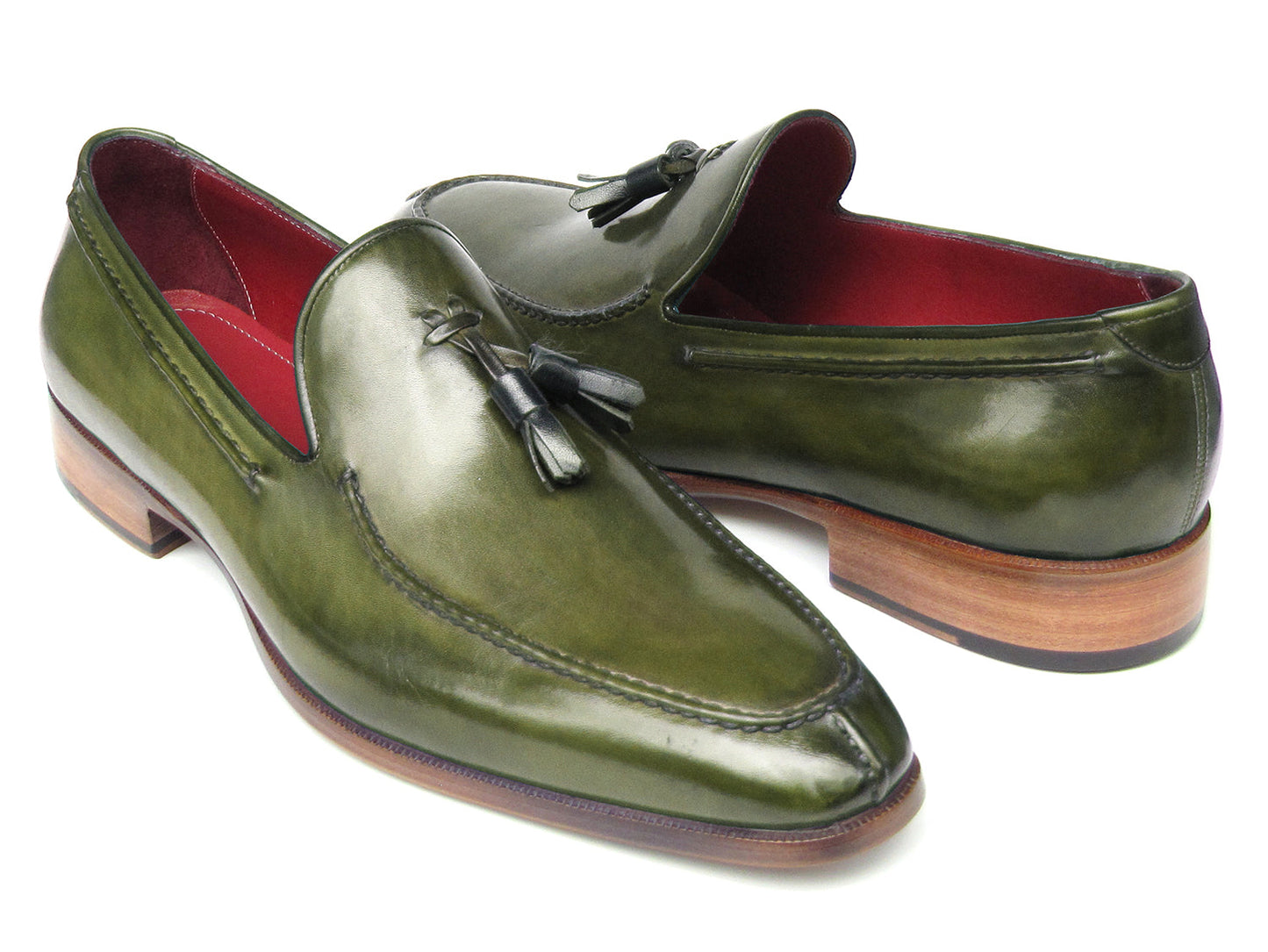 The Paul Parkman Tassel Loafer Green Hand Painted Leather - 083-GREEN features a pair of green hand-painted leather loafers with tassels and brown wooden soles; one shoe is upright, the other displays its sole.