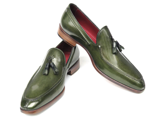 The Paul Parkman Tassel Loafer Green Hand Painted Leather - 083-GREEN features a pair of green hand-painted leather loafers with tassels and brown wooden soles; one shoe is upright, the other displays its sole.