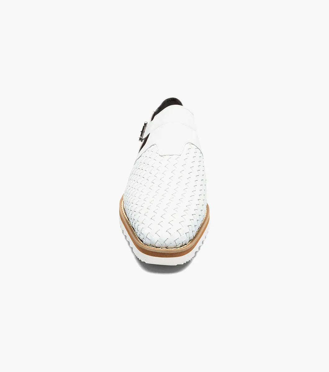 The Stacy Adams Alvarado Woven City Sandal in white features a woven leather upper, buckle strap, brown sole, white serrated outsole, and a soft memory foam insole for comfort. Displayed on a white background.