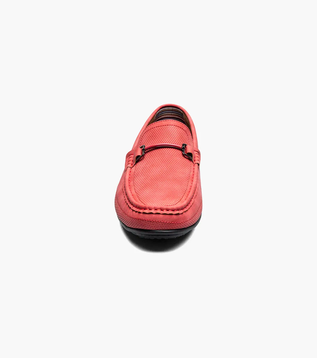 The Stacy Adams Colton Moc Toe Bit Slip On (25760-600) is a red suede loafer featuring a metal bit detail, visible stitching, black sole, striped inner lining, and cushioned footbed for comfort.