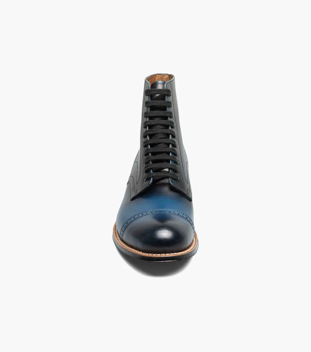 The STACY ADAMS Madison Cap Toe Lace Up Boot in blue (00110-400) is a leather dress boot with a cap toe and brogue detailing, displayed on a white background.