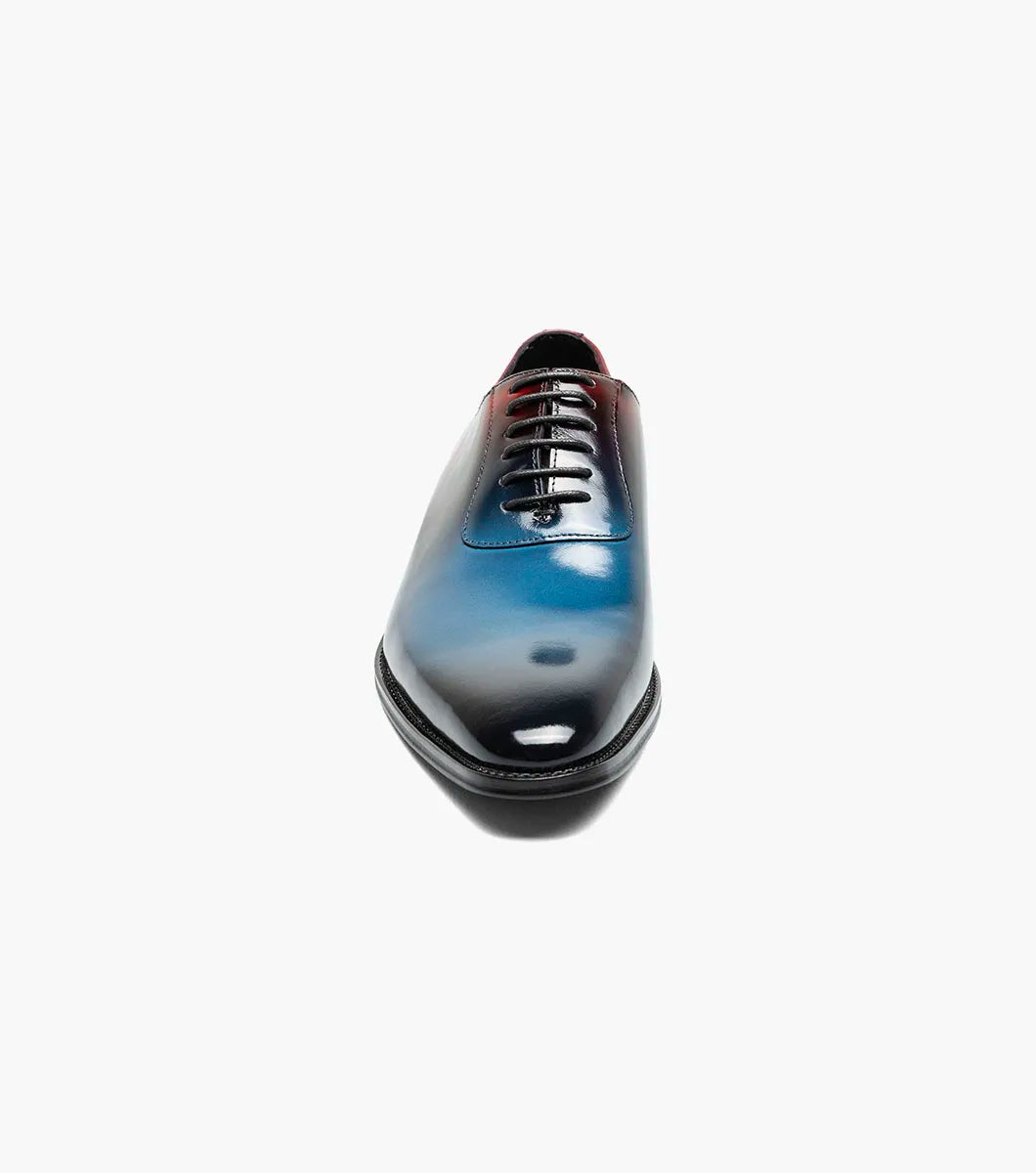 The STACY ADAMS Shaffer Plain Toe Oxford (Navy Multi, 25763-492) features premium calf leather with a gradient from deep red heel to blue toe, dark laces, and a black sole.