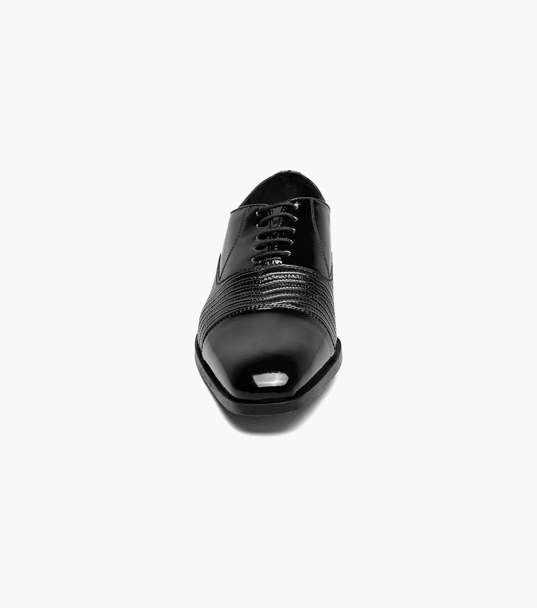 The Stacy Adams Razzeto Cap Toe Oxford in black features a patent leather lizard print, textured midsection, lace-up closure, and RedZone footbed for comfort, shown against a white background.