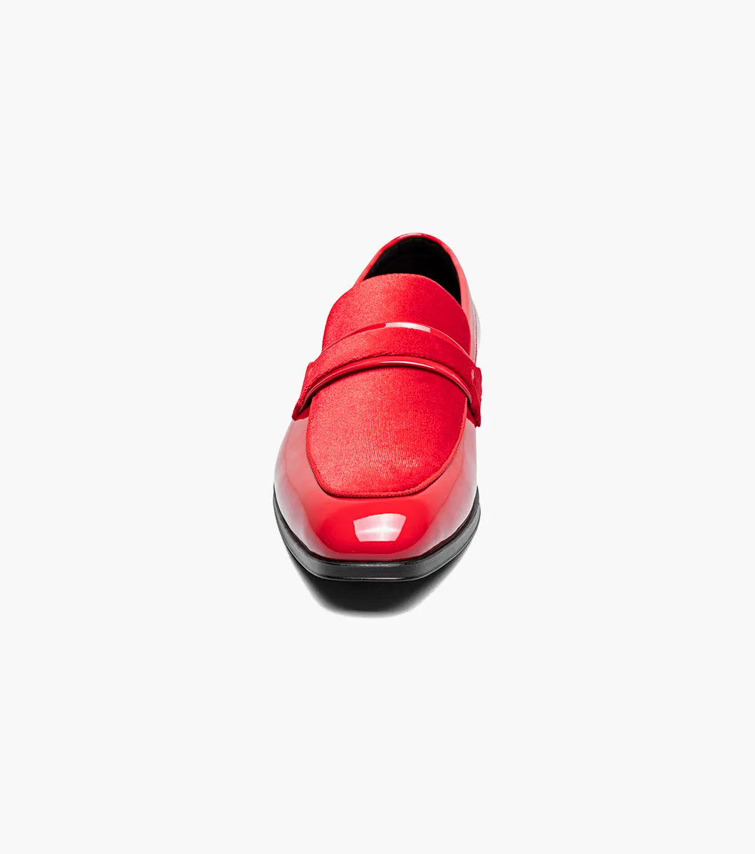 The Stacy Adams Spratley Moc Toe Saddle Slip On in red features a velour upper, matte strap, and black sole. This single shiny loafer (25686-600) by STACY ADAMS is displayed on a white background.