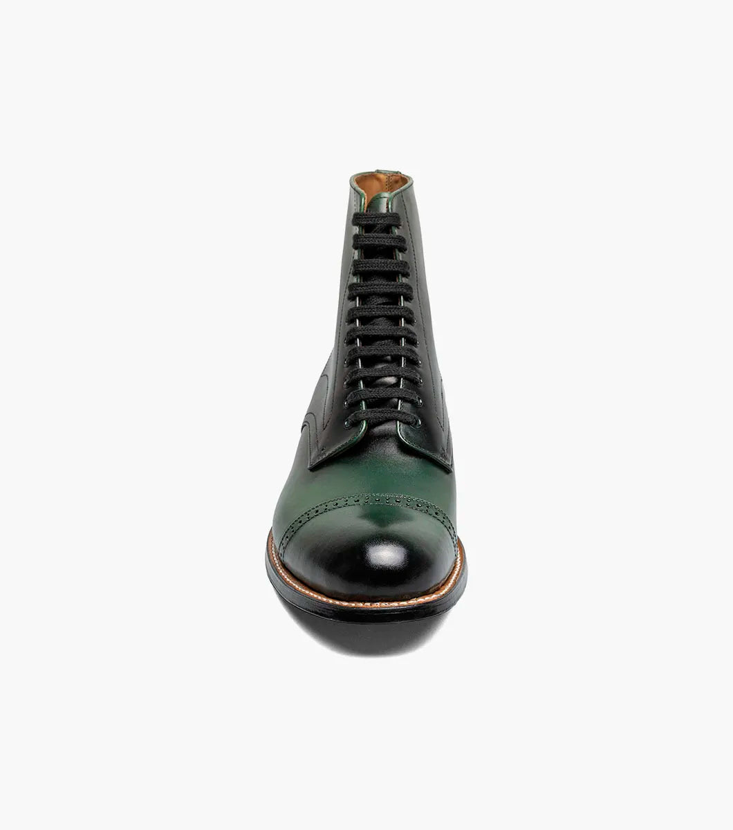 The Stacy Adams Madison Cap Toe Lace Up Boot (00110-300) features a dark green leather upper, black sole, brown welt, and closed lacing—an elegant STACY ADAMS dress boot shown on a white background.