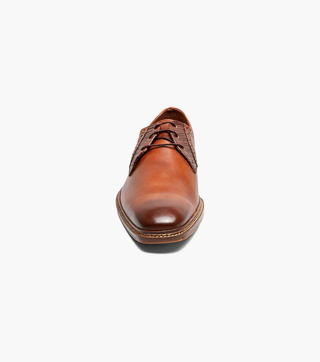The Stacy Adams Giorgetti Plain Toe Oxford in Cognac features lizard print leather, brogue details, textured accents, a cushioned footbed, low heel, and lace-up closure.