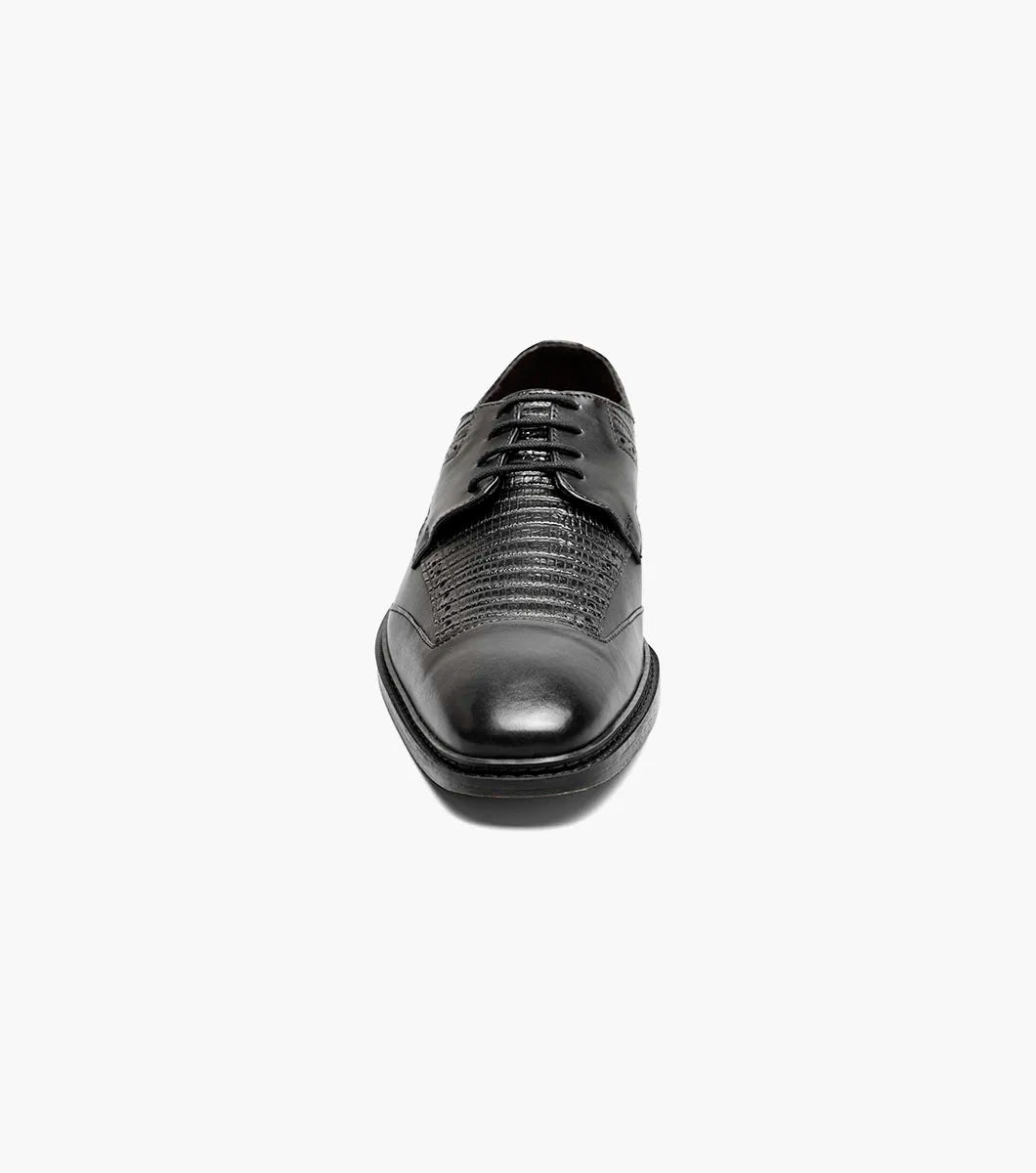 The Stacy Adams Gambetta Modified Cap Toe Oxford (25780-001) is a black leather dress shoe with textured detailing, lace-up closure, low heel, and RedZone footbed, shown on a plain white background.