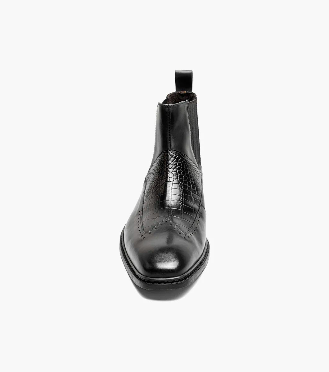 The Stacy Adams Garza Wingtip Chelsea Boot (Black, 25782-001) features crocodile texture accents, elastic side panels, a heel pull tab, and a low heel on a flat sole.