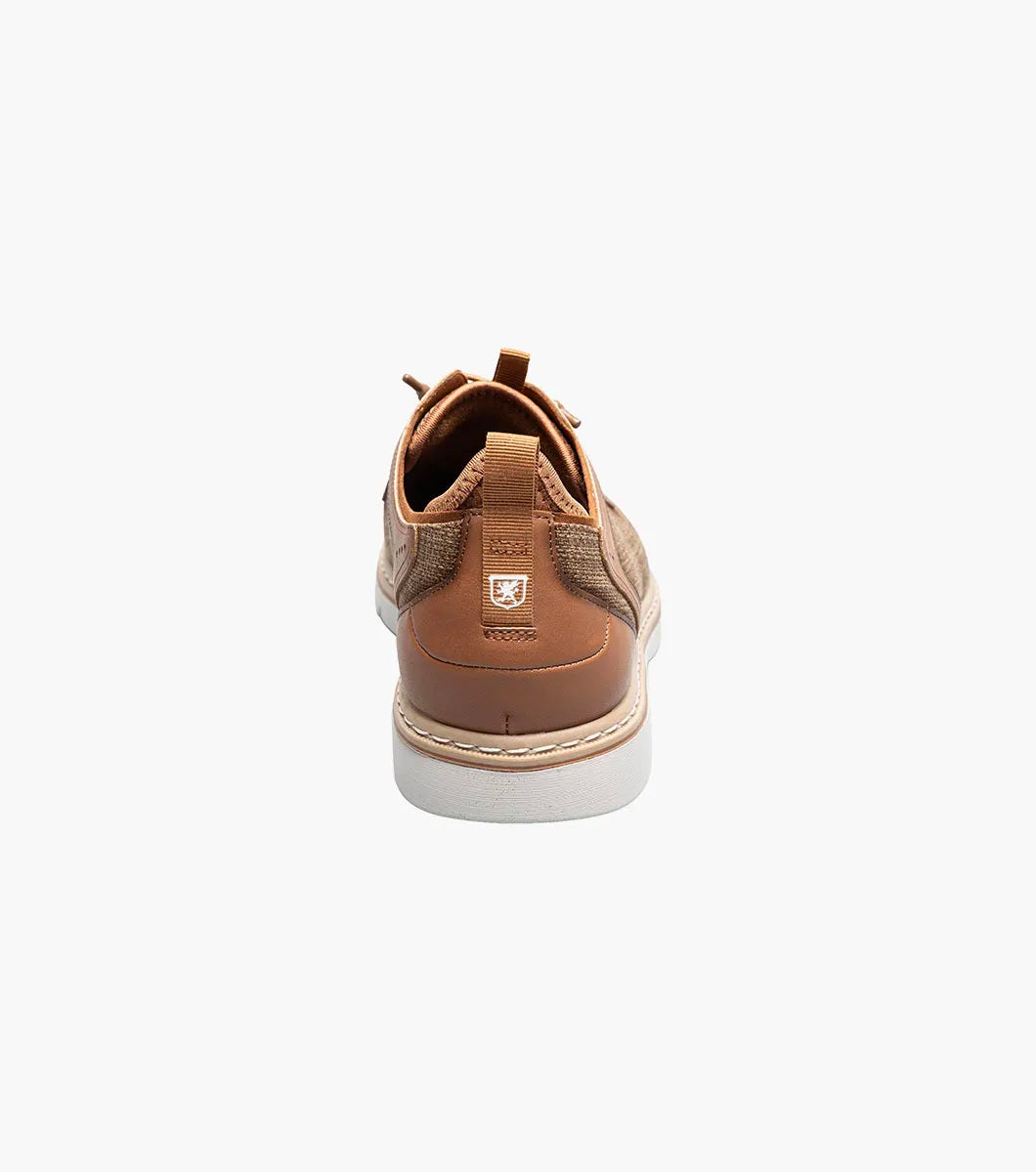 The Stacy Adams Sebert Plain Toe Elastic Lace Up in tan features a textured fabric upper, leather accents, anatomical arch support, and a light rubber sole for comfort, shown on a white background.