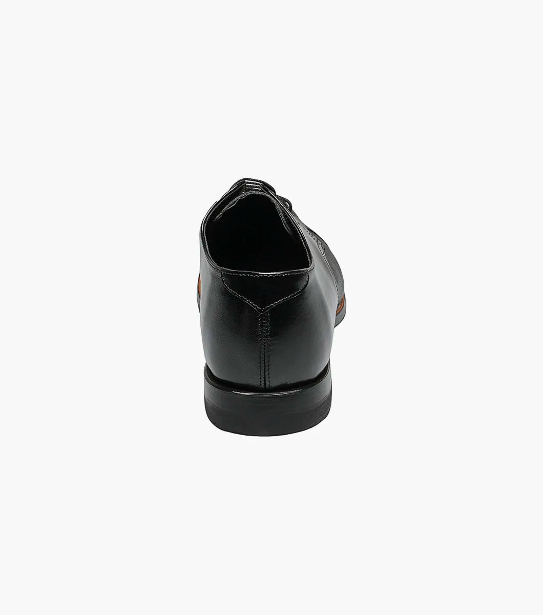 The Stacy Adams Madison Lizard Cap Toe Oxford (00049-01) is a black kidskin leather dress shoe for men, featuring a lizard print cap toe and five eyelets, shown against a white background. Brand: STACY ADAMS.