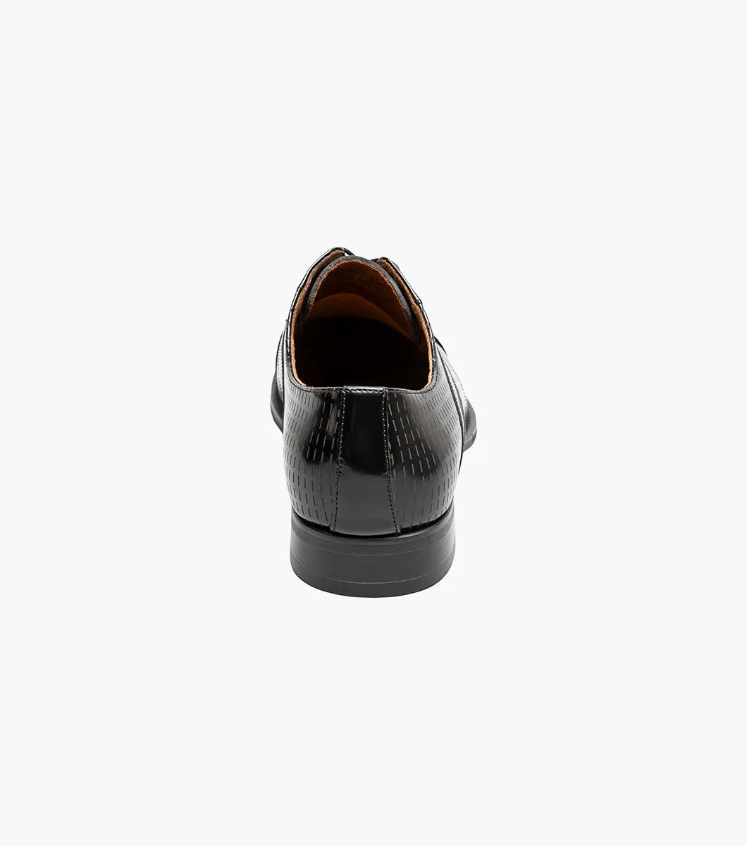 The Stacy Adams Hobson Cap Toe Oxford (25764-001) is a single black dress shoe with shiny, laser-etched geometric leather and black laces, displayed on a plain white background.