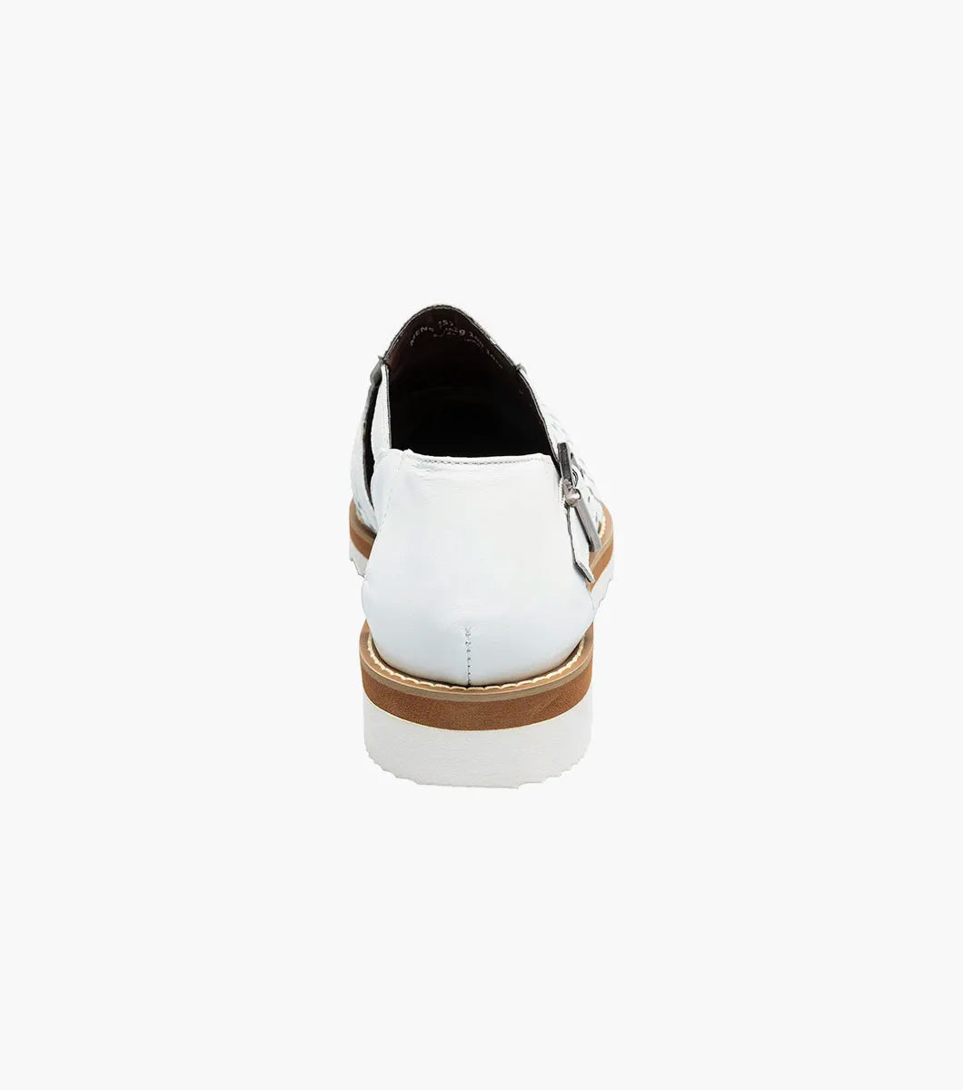 The Stacy Adams Alvarado Woven City Sandal in white features a woven leather upper, buckle strap, brown sole, white serrated outsole, and a soft memory foam insole for comfort. Displayed on a white background.