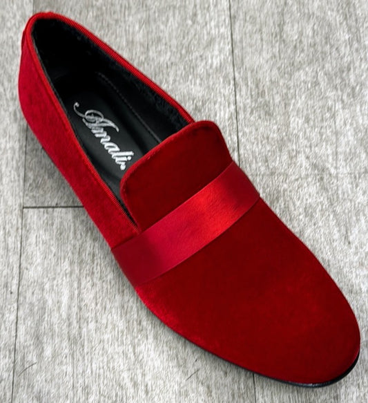 The Exclusive Formal Dress Shoe Red 7021 from UNIQUE DESIGN MENSWEAR, a sophisticated red velvet slip-on crafted from suede leather and featuring a satin band, sits gracefully on a gray wooden floor.