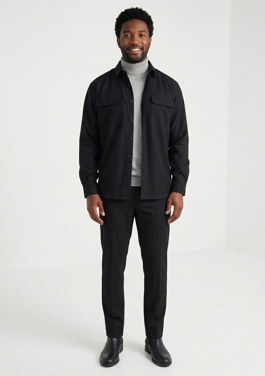A person wearing the Inserch Two-Pocket 2pc Set SE004-00001 Black by Inserch, styled over a light gray turtleneck sweater, shown from the shoulders to hips against a beige background.