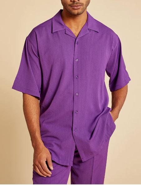 A person wears the Inserch 2pc Set (Shirts and Pants) in Plum, by Inserch—featuring a regular fit, short-sleeve button-up shirt and matching pants—standing with one hand in their pocket against a beige background.