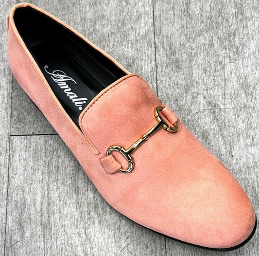 A coral suede leather loafer, embellished with a gold metal bit detail, sits gracefully on a gray wooden floor. Inside, "UNIQUE DESIGN MENSWEAR" is imprinted, reflecting the Italian craftsmanship associated with full genuine leather elegance.