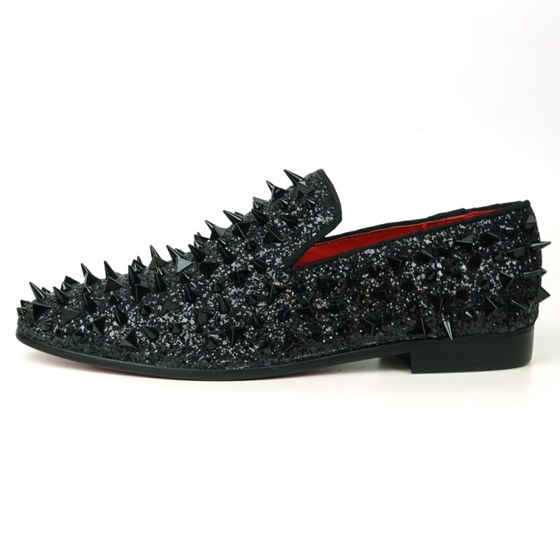 The FI-7517 Black Glitter Black Spikes Slip On Loafer by Fiesso is a striking masterpiece, adorned with black spikes and glitter, featuring a luxurious red interior lining. This exquisite shoe boasts a leather upper that promises both elegance and durability.