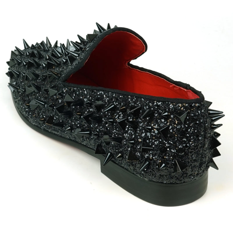 The FI-7517 Black Glitter Black Spikes Slip On Loafer by Fiesso is a striking masterpiece, adorned with black spikes and glitter, featuring a luxurious red interior lining. This exquisite shoe boasts a leather upper that promises both elegance and durability.