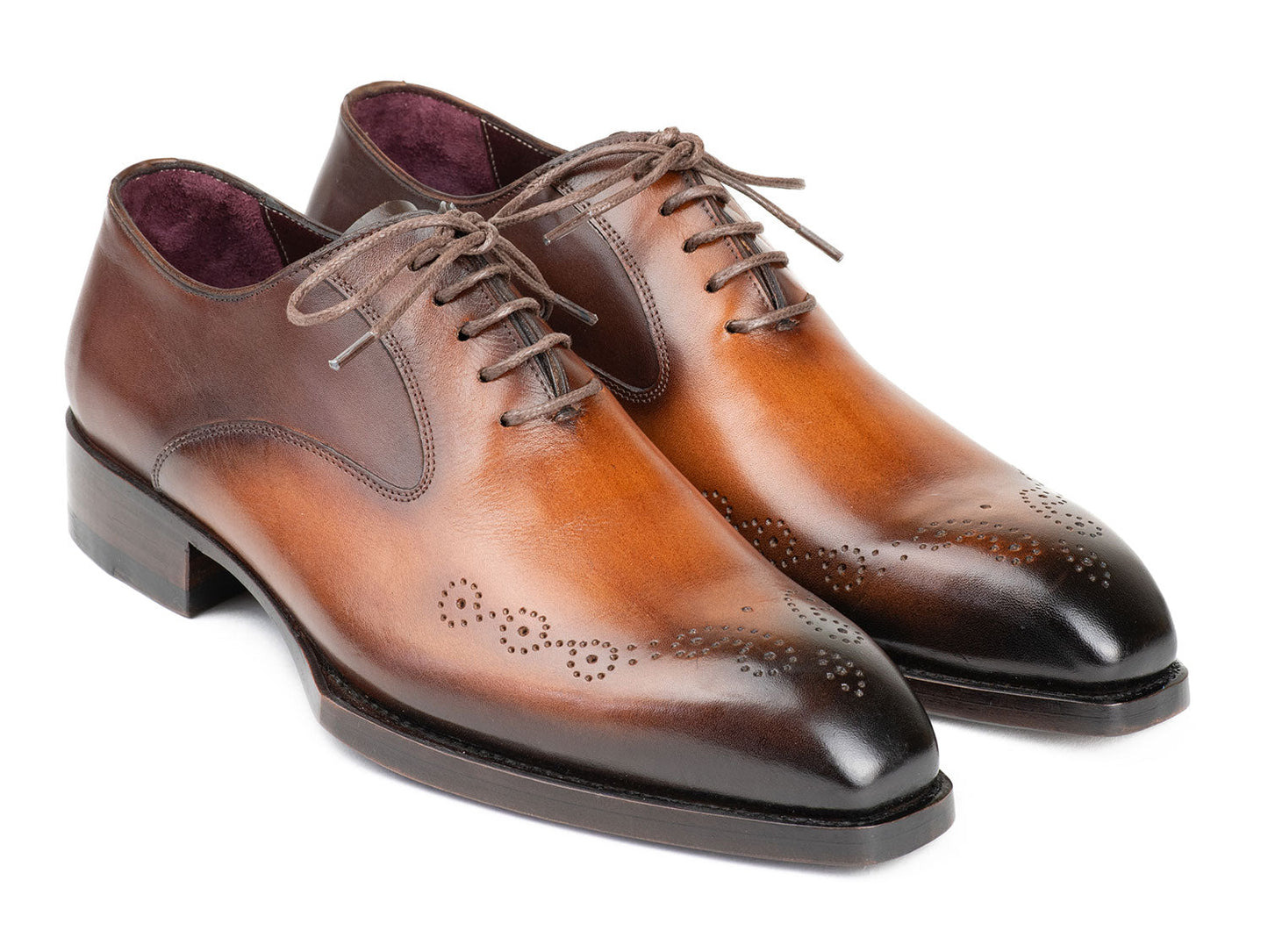The Paul Parkman Goodyear Welted Punched Oxfords Brown & Camel - 5364-BRC are expertly crafted dress shoes featuring decorative perforations, a polished finish, and laces. Made-to-order by Paul Parkman, these shoes offer a durable Goodyear welted construction and timeless style.