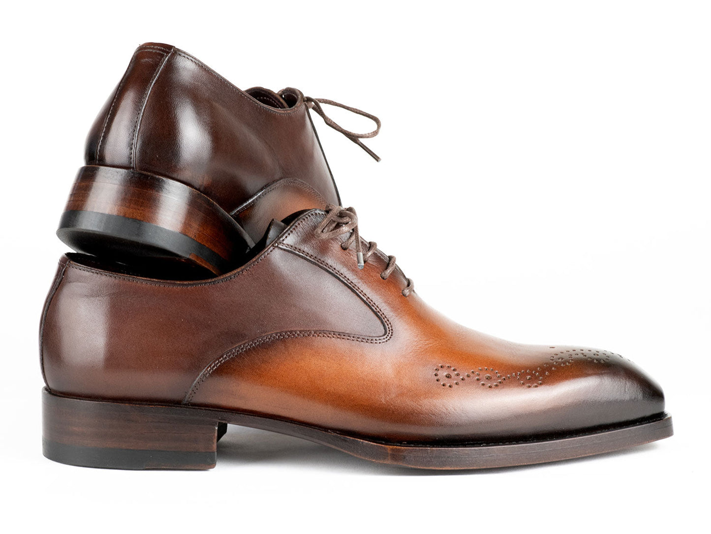 The Paul Parkman Goodyear Welted Punched Oxfords Brown & Camel - 5364-BRC are expertly crafted dress shoes featuring decorative perforations, a polished finish, and laces. Made-to-order by Paul Parkman, these shoes offer a durable Goodyear welted construction and timeless style.