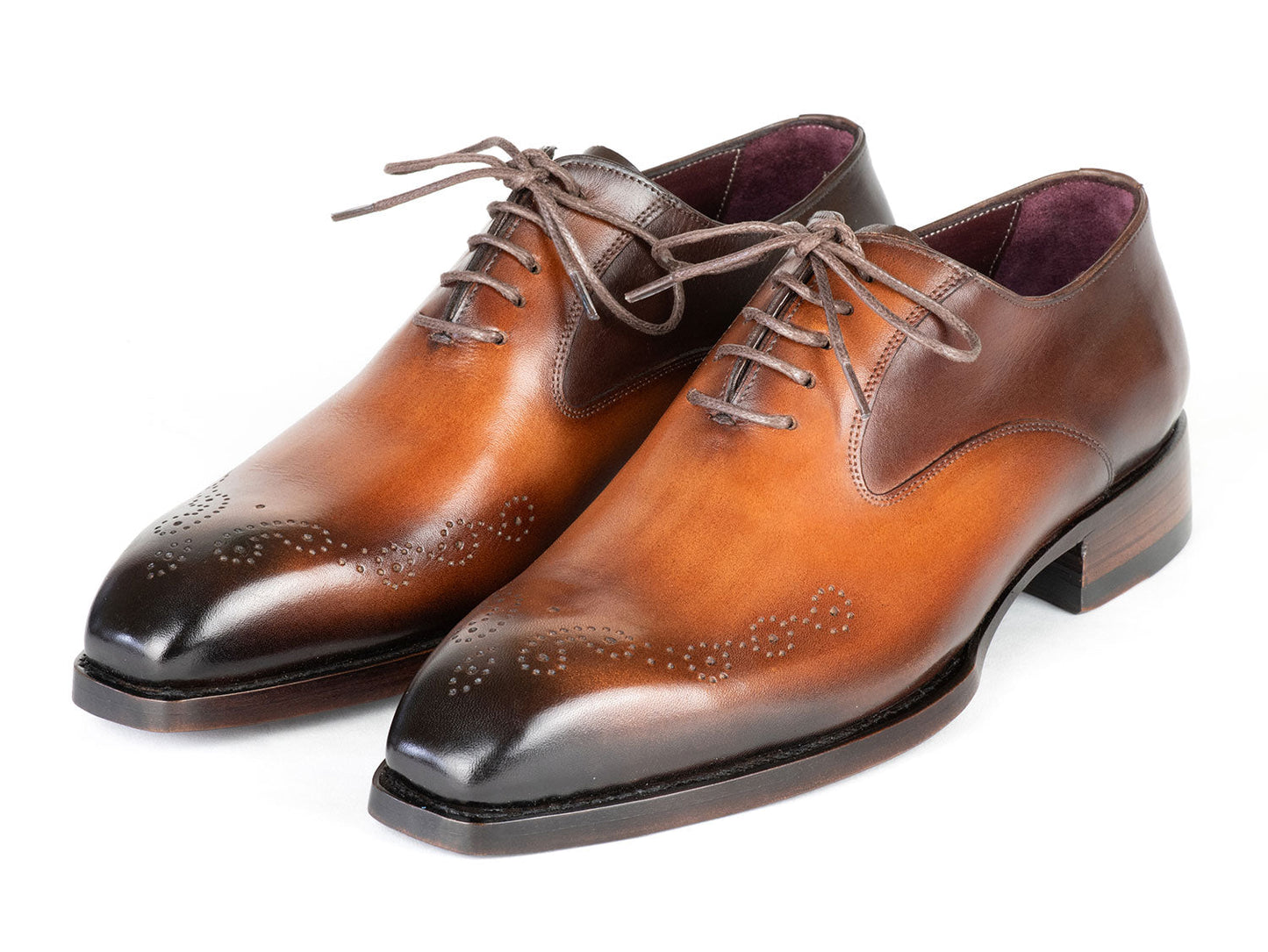 The Paul Parkman Goodyear Welted Punched Oxfords Brown & Camel - 5364-BRC are expertly crafted dress shoes featuring decorative perforations, a polished finish, and laces. Made-to-order by Paul Parkman, these shoes offer a durable Goodyear welted construction and timeless style.