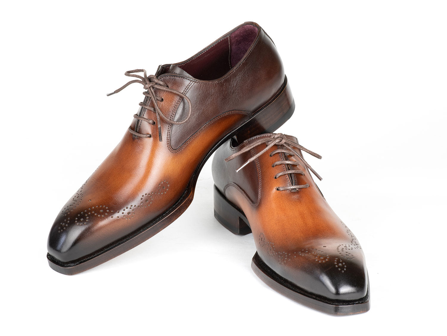 The Paul Parkman Goodyear Welted Punched Oxfords Brown & Camel - 5364-BRC are expertly crafted dress shoes featuring decorative perforations, a polished finish, and laces. Made-to-order by Paul Parkman, these shoes offer a durable Goodyear welted construction and timeless style.