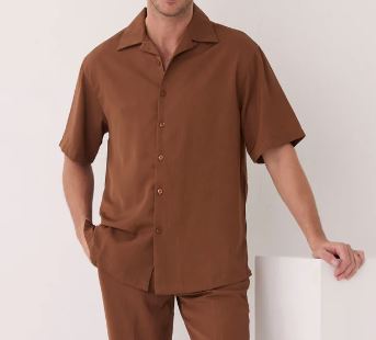 A man wears the Inserch 2pc Set (Shirts and Pants) Mocha by Inserch, featuring a short-sleeve button-up mocha shirt and matching pants, standing against a plain background.