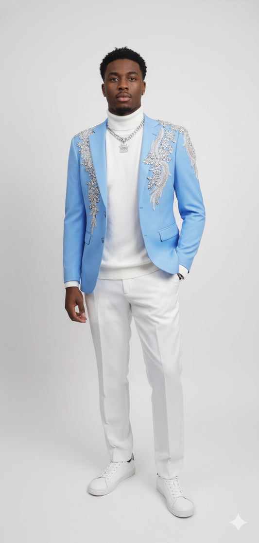 A man stands against a plain background wearing the Unique Design Menswear Custom Prom Suit Light Blue with Silver Rhinestones, paired with a white turtleneck, white pants, and white sneakers.