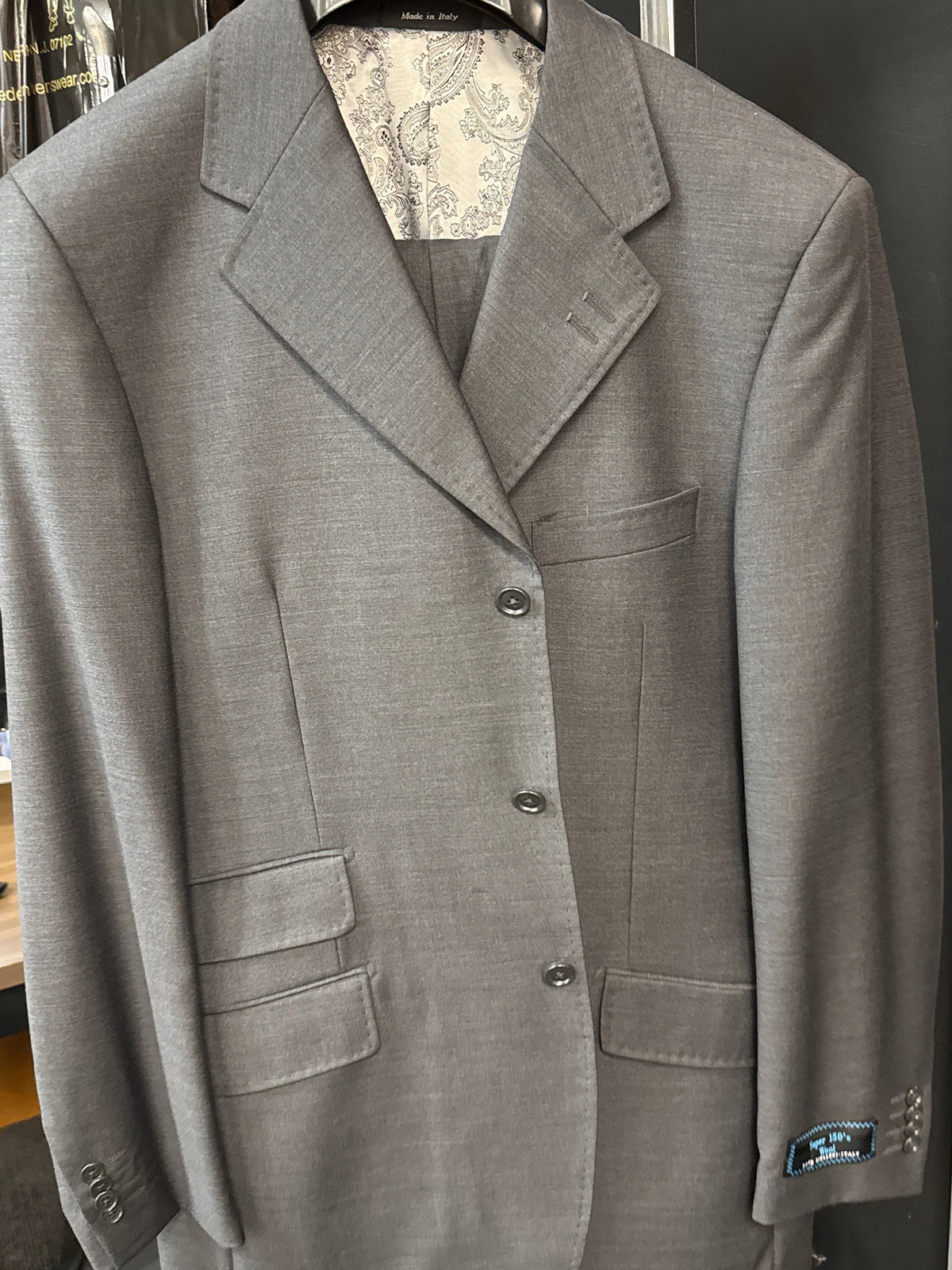 An older man in a Tiglio “BASITO” Charcoal Wide Leg Pure Wool Suit by Tiglio Rosso stands facing forward in a studio with a neutral background and soft lighting.