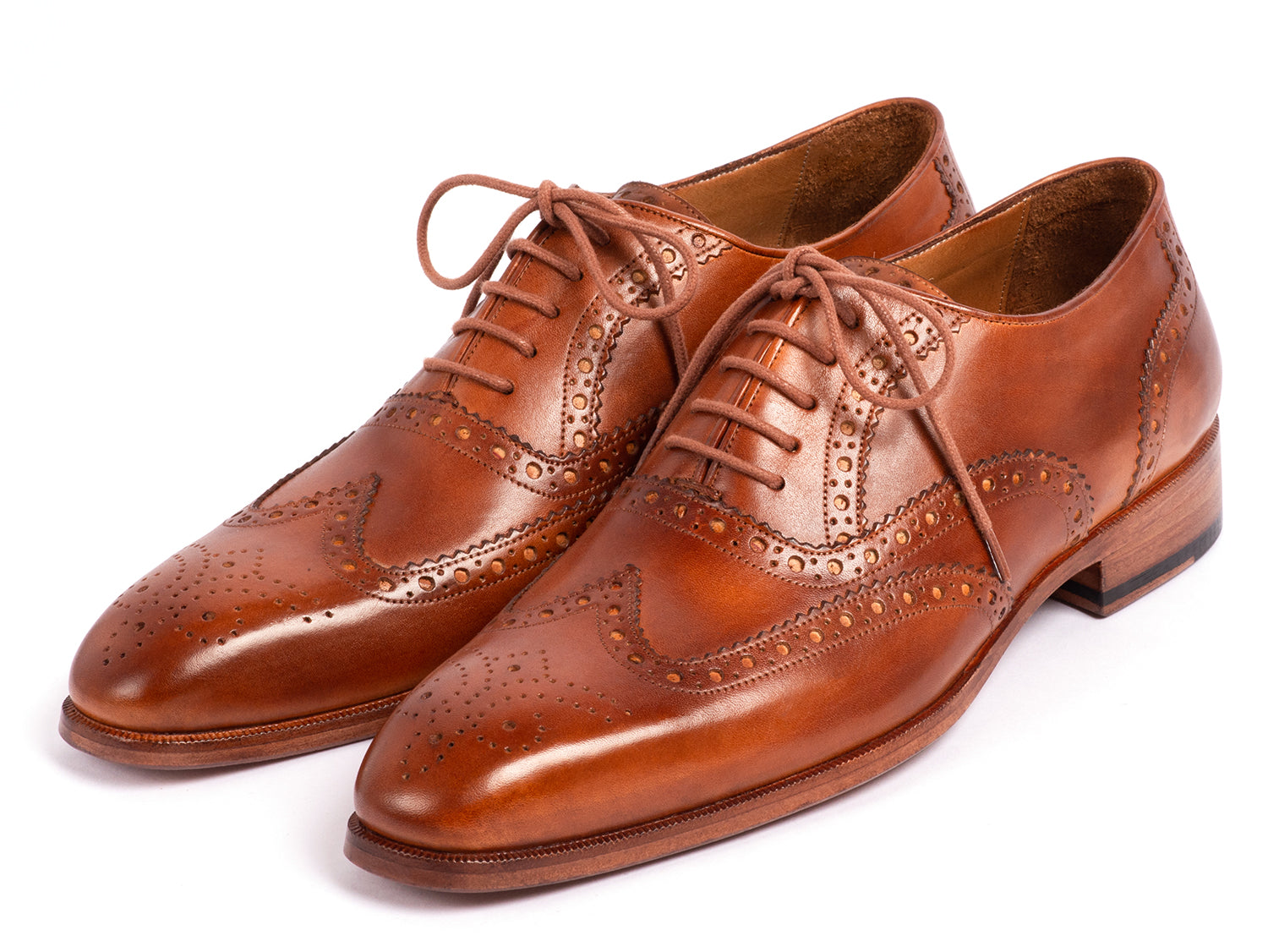 The Paul Parkman Wingtip Oxfords Mid Brown - 5447-BRW are brown hand-painted leather brogues with decorative perforations and laces, displayed against a white background.