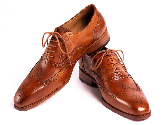 The Paul Parkman Wingtip Oxfords Mid Brown - 5447-BRW are brown hand-painted leather brogues with decorative perforations and laces, displayed against a white background.