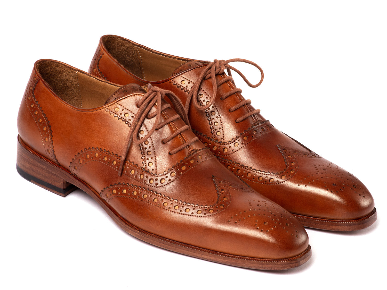 The Paul Parkman Wingtip Oxfords Mid Brown - 5447-BRW are brown hand-painted leather brogues with decorative perforations and laces, displayed against a white background.